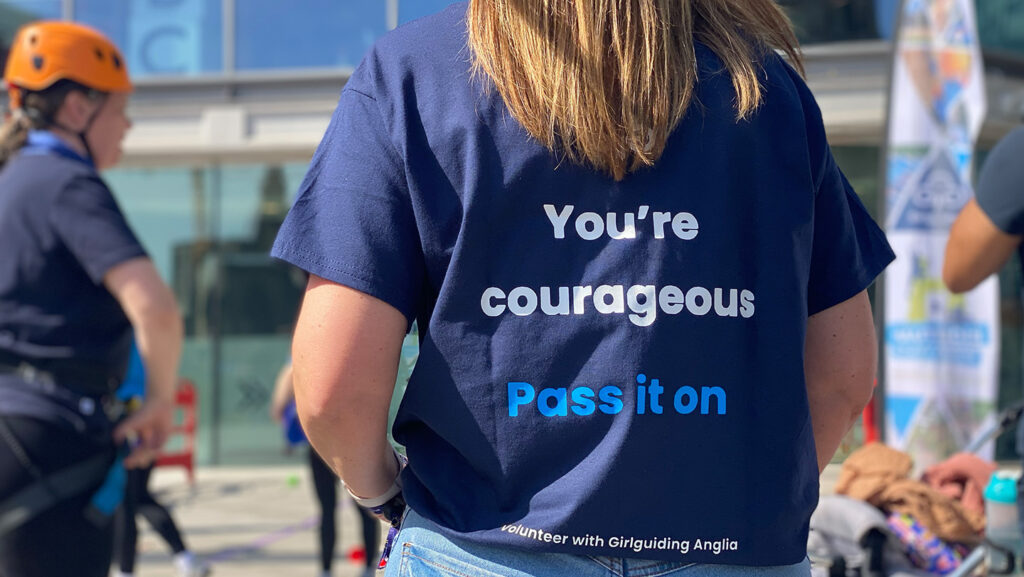 The back of the dark blue t-shirts worn by the Girlguiding Anglia teams at the volunteer campaign launch event.