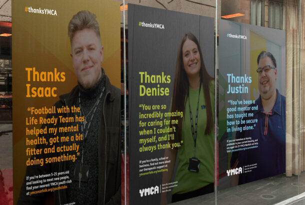 Three thanks YMCA posters in a window